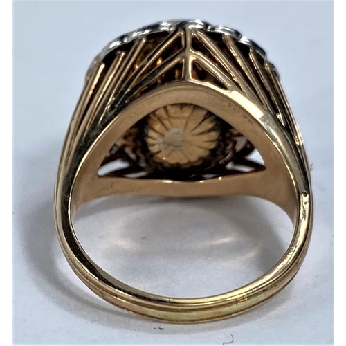 647 - A yellow metal dress ring set with a domed pearl surrounded by diamond chips in a rope twist border,... 