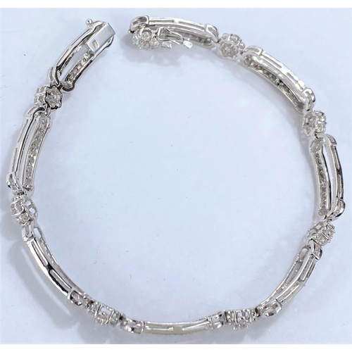 648 - A white gold Art Deco style bracelet set with alternating encrusted elongated and flower head links,... 