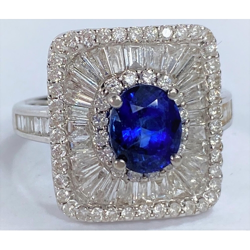 649 - An 18ct white gold Art Deco style dress ring set with an oval sapphire in rectangular 3 tier setting... 