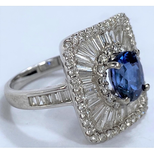 649 - An 18ct white gold Art Deco style dress ring set with an oval sapphire in rectangular 3 tier setting... 