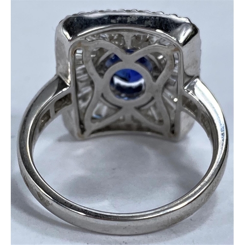 649 - An 18ct white gold Art Deco style dress ring set with an oval sapphire in rectangular 3 tier setting... 