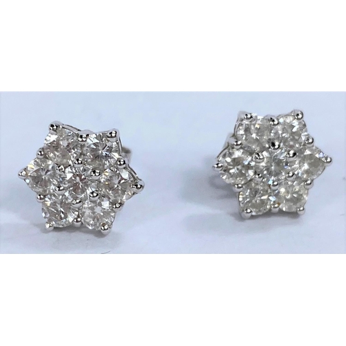 650 - A pair of white metal earrings each with 7 diamonds in flower head setting (pierced) 2.8gms