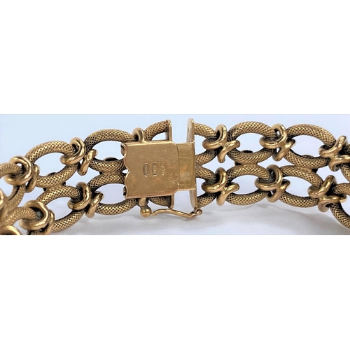 653 - A yellow metal gate bracelet formed from figure of 8 links, stamped 