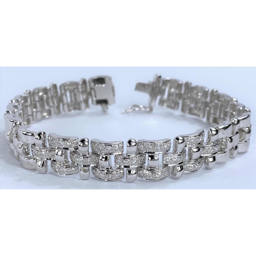 658 - A white metal gate bracelet, central 9 links encrusted with diamonds, stamped '18K' and 1.00 36.4gms