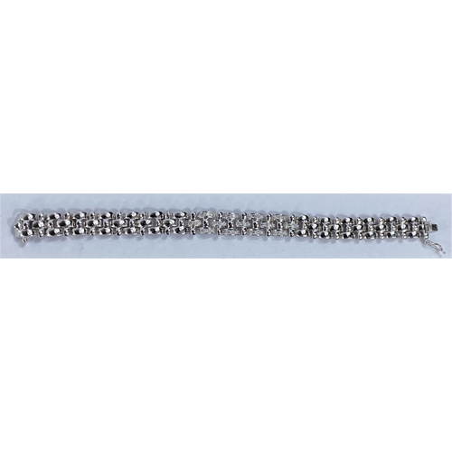 658 - A white metal gate bracelet, central 9 links encrusted with diamonds, stamped '18K' and 1.00 36.4gms