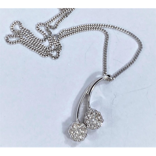 663 - An 18ct hallmarked white gold pendant set with 2 flower head diamond clusters on fine chain, 5.4gms