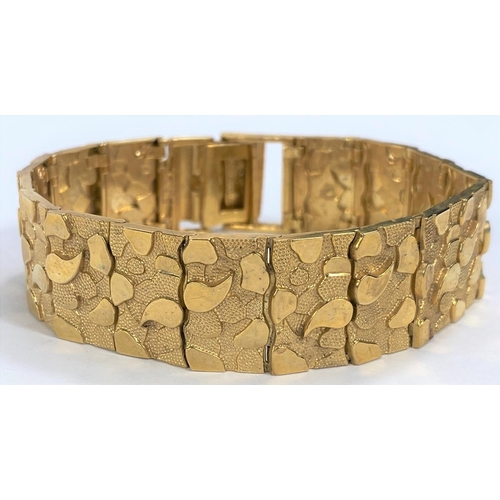 664 - A  gold bracelet each link set with raised stamped 9K, polished and matt motifs, 27.2gms, length 18.... 