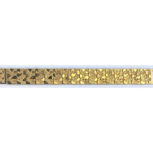 664 - A  gold bracelet each link set with raised stamped 9K, polished and matt motifs, 27.2gms, length 18.... 