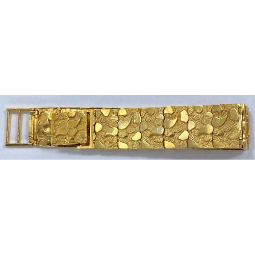 664 - A  gold bracelet each link set with raised stamped 9K, polished and matt motifs, 27.2gms, length 18.... 