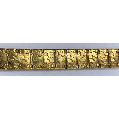 664 - A  gold bracelet each link set with raised stamped 9K, polished and matt motifs, 27.2gms, length 18.... 