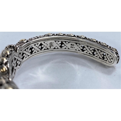 671 - John Hardy, an intricate pierced silver bangle with central circular blue topaz flanked by 2 rectang... 