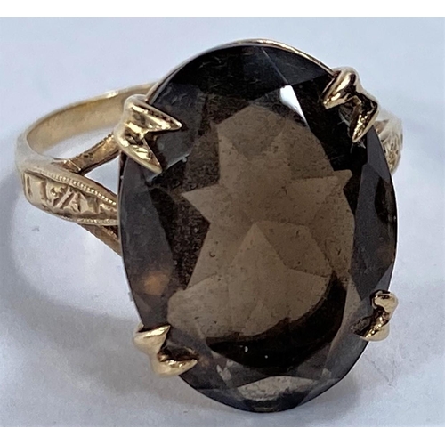 696 - A 9 carat hallmarked gold dress ring set large oval smoky quartz size O; a 9 carat hallmarked gold w... 