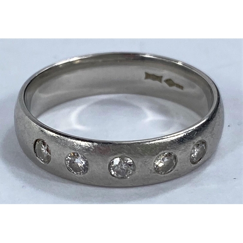 708 - A hallmarked platinum wedding ring, barrel shaped and inset with 5 diamonds, 6.5 gm size O