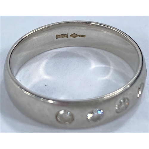 708 - A hallmarked platinum wedding ring, barrel shaped and inset with 5 diamonds, 6.5 gm size O