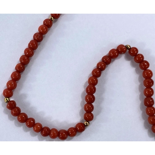 713 - A pink coral bead necklace with interspersed gold beads, the clasp stamped '750', 14gms, 4mm bead si... 