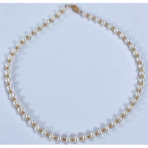 715 - A necklace formed from alternating cultured pearls and gold beads, the clasp stamped '585'