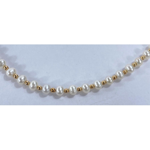 715 - A necklace formed from alternating cultured pearls and gold beads, the clasp stamped '585'