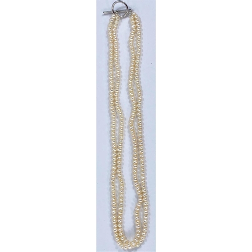 716 - A long necklace formed from cultured pearls and gold coloured beads interspersed with faceted smoky ... 