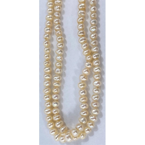 716 - A long necklace formed from cultured pearls and gold coloured beads interspersed with faceted smoky ... 