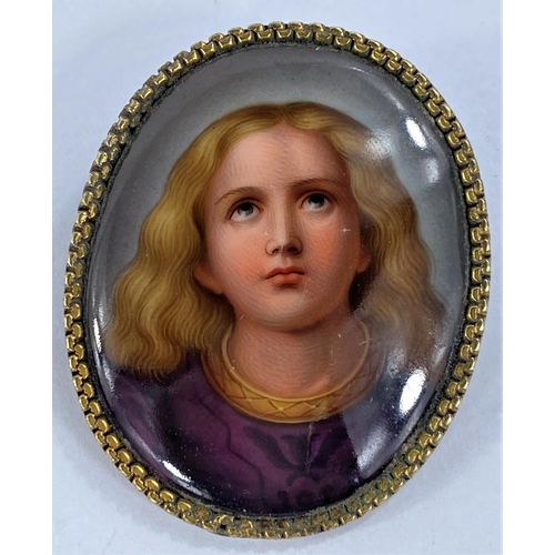 729 - A Victorian female head cameo in rope twist gilt metal surround; a porcelain brooch depicting a youn... 