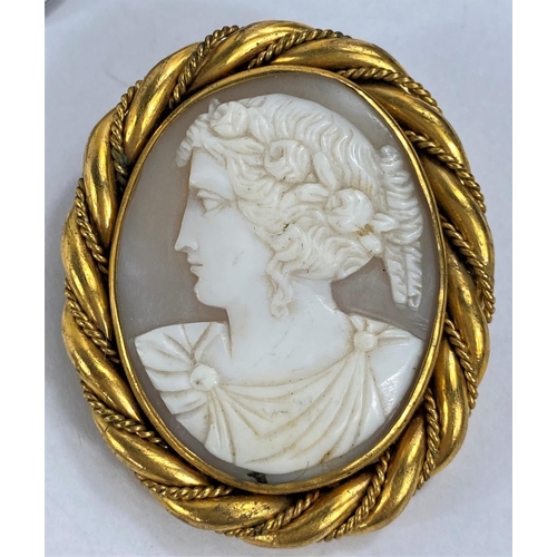 729 - A Victorian female head cameo in rope twist gilt metal surround; a porcelain brooch depicting a youn... 