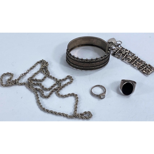 738 - A hallmarked silver bangle, two silver rings, a silver gate bracelet and chain 2.5oz