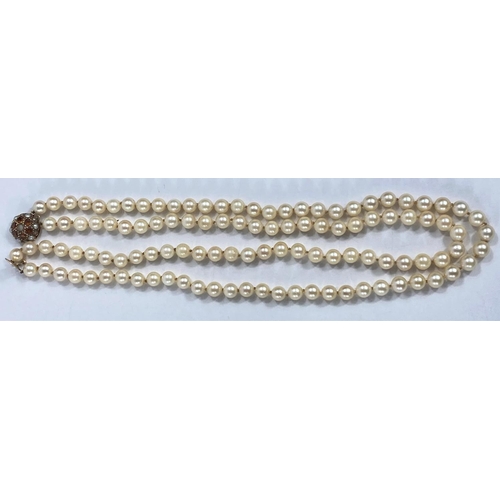 759 - A double string cultured pearl necklace with 9ct gold clasp set with citrines and seed pearls, lengt... 