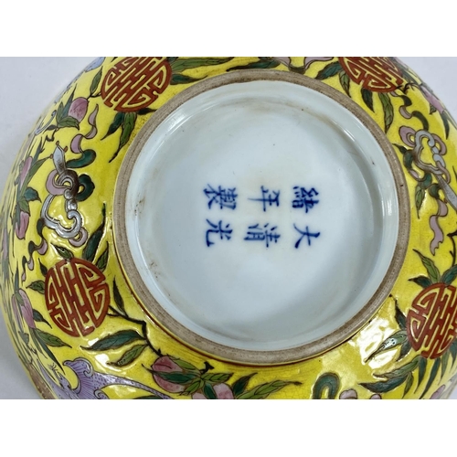 430 - A Chinese yellow ground bowl, decorated to exterior with bats in different colours, 6 character to b... 