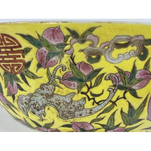 430 - A Chinese yellow ground bowl, decorated to exterior with bats in different colours, 6 character to b... 