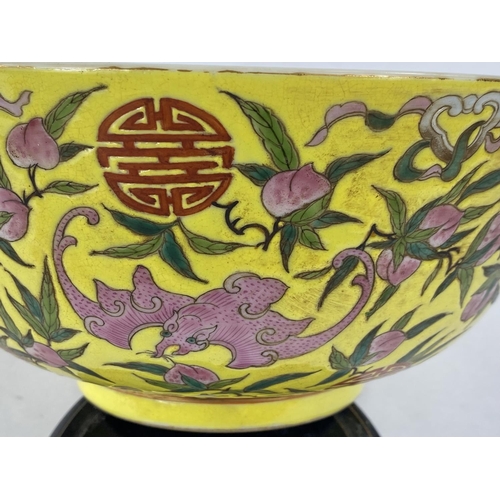 430 - A Chinese yellow ground bowl, decorated to exterior with bats in different colours, 6 character to b... 