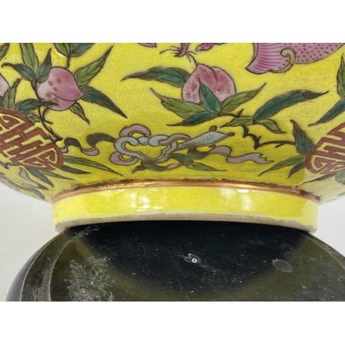 430 - A Chinese yellow ground bowl, decorated to exterior with bats in different colours, 6 character to b... 