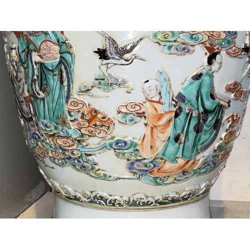 452 - A large Chinese vase decorated with deities and cranes in relief, with dragon decoration to the neck... 