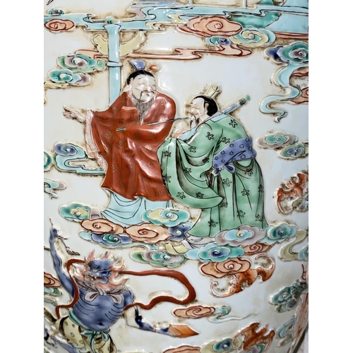 452 - A large Chinese vase decorated with deities and cranes in relief, with dragon decoration to the neck... 