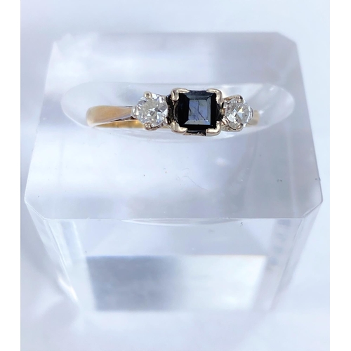 608A - A lady's dress ring set with square cut sapphire flanked by 2 diamonds, 18k, size L , 2.24gms