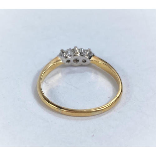 608B - A lady's dress ring set with 3 diamonds in yellow metal shank, 18k, size M 1.77gm size