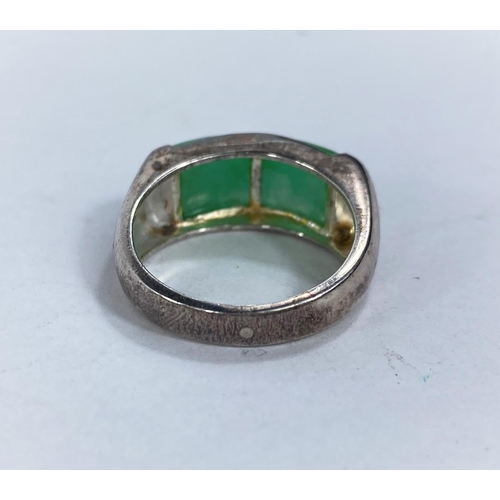 608D - A white metal dress ring set with rounded oblong jade coloured stone, stamped '925' 5.66gms size O/P