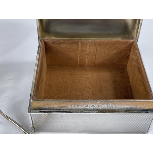 619 - A hallmarked silver engine turned cigarette box, London 1918; an oriental white metal sauce boat; a ... 