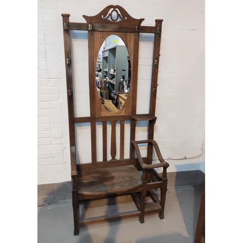 801 - An Arts & Crafts hall stand with mirror back, seat and 2 stick stands