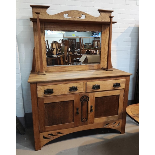 802 - An Arts & Crafts oak sideboard with mirror back, square pillars, 2 side cupboards and2 drawers