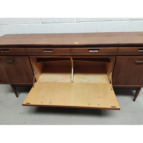 894 - A mid 20th century teak sideboard by White & Newton with four Chamfour barnacled drawers, a fall... 