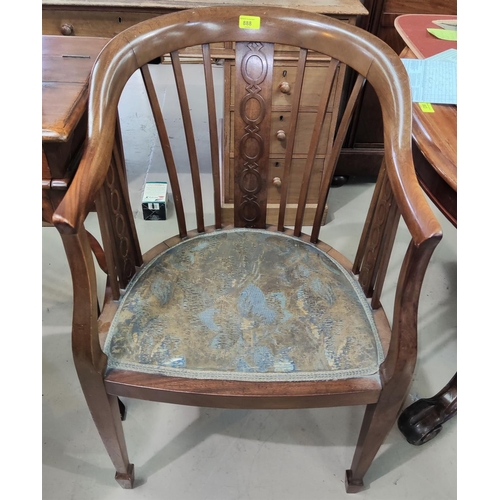 888 - An Edwardian mahogany bow armchair with central carved support on tapering legs