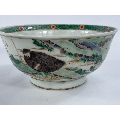 431 - A Chinese bowl decorated with Chinese characters, oxen & farmer, 20cm diameter.