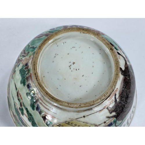 431 - A Chinese bowl decorated with Chinese characters, oxen & farmer, 20cm diameter.