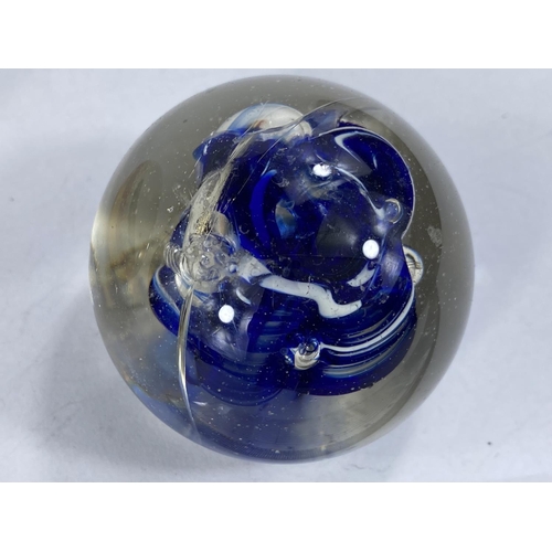 584 - A Murano handmade paperweight with Koi carp interior, a smaller paperweight and 2 Nat West pigs