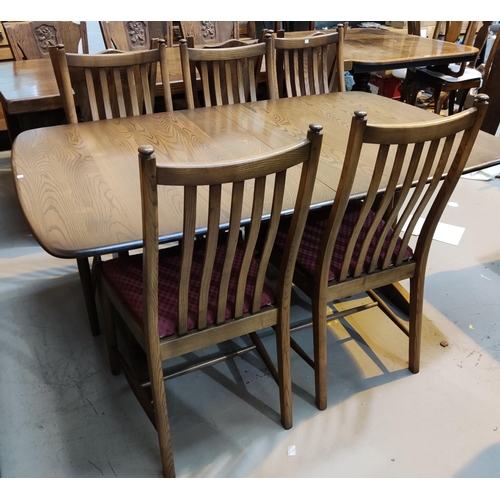 825 - A modern Ercol elm dining suite comprising table with extending rectangular top, 2 spare leaves, and... 