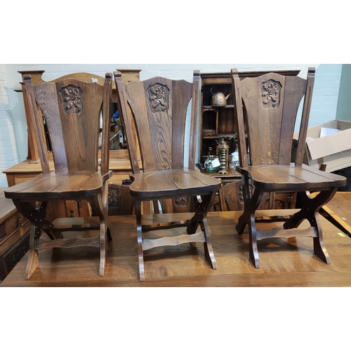 830 - An oak period style dining suite, the table with heavy plank top and square legs, 6 chairs with shie... 