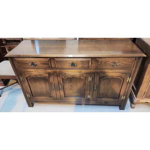 831 - A Georgian style distressed oak sideboard with 3 drawers and 3 arch panel doors