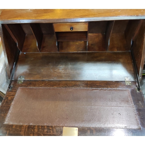 833 - A 1930's oak bureau with fall front and 2 drawers under