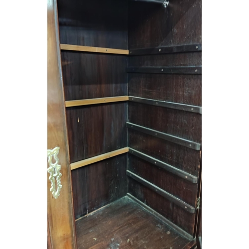 874 - A Georgian mahogany press cupboard, the upper section enclosed by 2 doors, 2 long and 2 short drawer... 