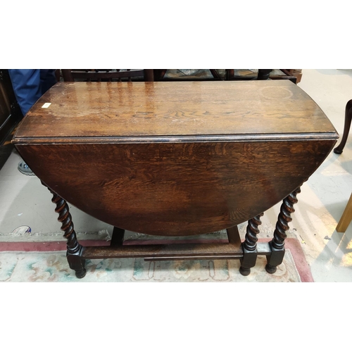 892 - An oak barley twist drop leaf table of oval form length 102cm